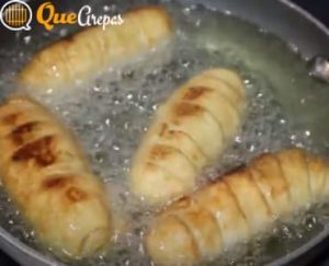 Tequeños in frying pan with oil - quearepas.com